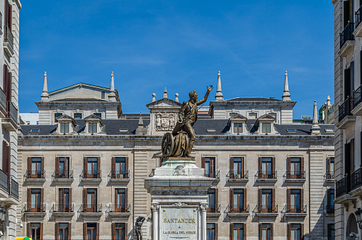 Madrid, Spain - September 25, 2022: View of the monument to Alfonso XII. The monument depicts a large colonnade  with several sculptures surrounding an equestrian statue of a king.