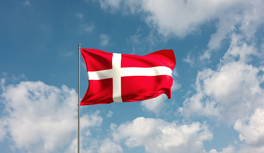Flag of Denmark blowing in the wind. Full page Danish flying flag. 3D illustration.