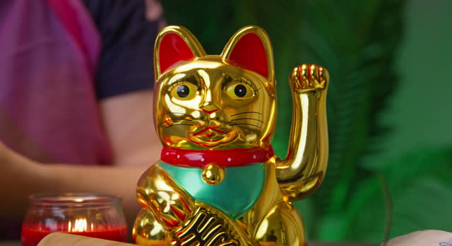 Close-up of a Maneki-Neko, the beckoning cat, a common Japanese figurine believed to bring good luck