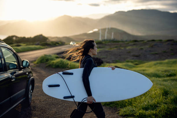 istock Surfing and eco mind. Surfer girl driven to surf. 2064280421