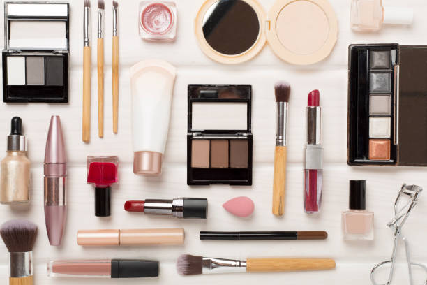 istock Flat lay with makeup products and tools on wooden background 2064295582