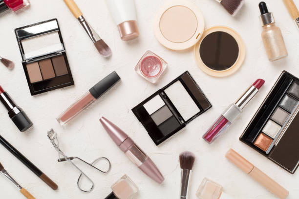 istock Flat lay with makeup products and tools on concrete background 2064295585