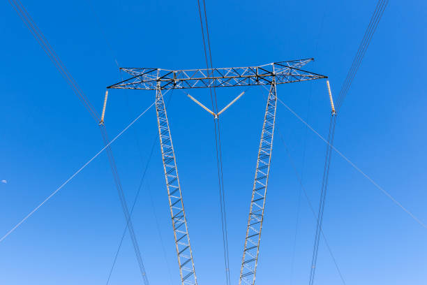istock High voltage power towers on a farm 2064300292