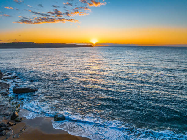 istock Aerial sunrise views over the ocean and beach 2064327646