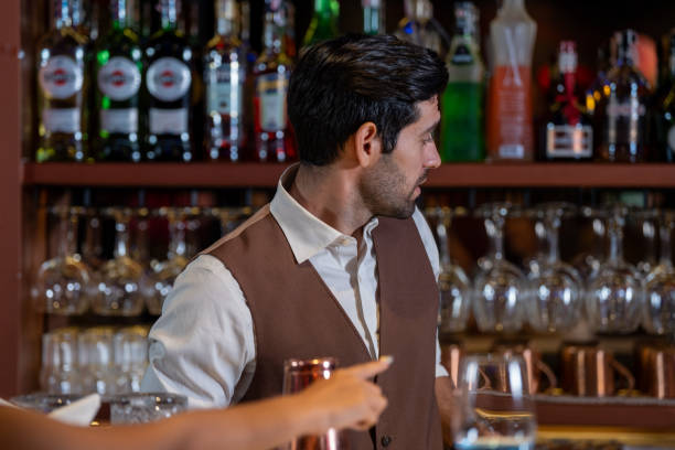 istock Man bartender is making a drink and dancing at bar. Dance party with group people dancing . Women and men have fun and drinking martini cocktail in night club. 2064342055
