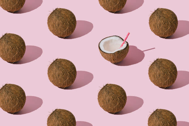 istock Fruit pattern made of coconuts on light pastel pink background. Minimal tropical beach concept. Nature summer composition. Trendy summertime party idea. Coconut aesthetic. Creative food background. 2064349130