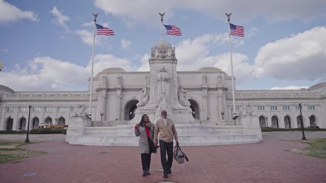 Retired couple standing outside Washington DC Metro Station while on winter vacation
