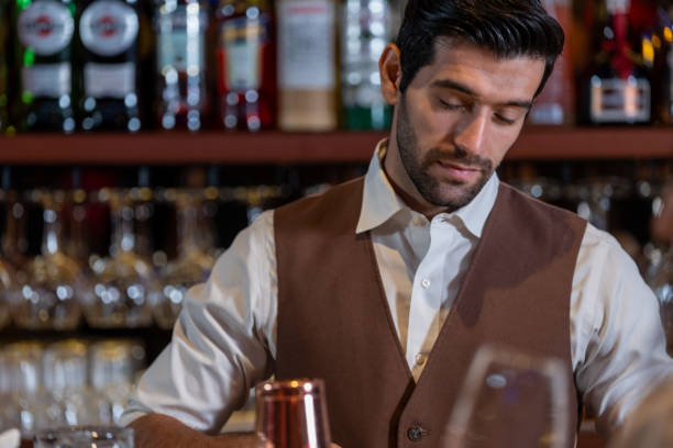 istock Man bartender is making a drink and dancing at bar. Dance party with group people dancing . Women and men have fun and drinking martini cocktail in night club. 2064353702