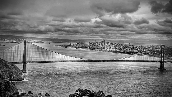 Monochromatic travel background cityscape and cloudscape. National landmark Golden Gate Bridge. Hawk Hill, Marin Headlands, CA, USA.distant