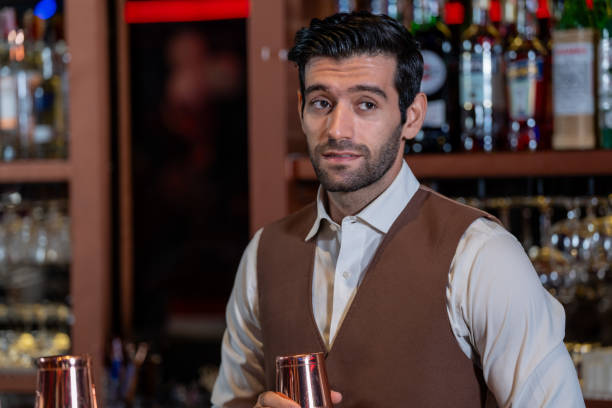 istock Man bartender is making a drink and dancing at bar. Dance party with group people dancing . Women and men have fun and drinking martini cocktail in night club. 2064359070
