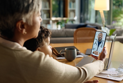 Video call, phone and parents with child for doctor for medical service, consulting and telehealth. Healthcare, medicine and mother and kid on smartphone for advice, discussion and communication