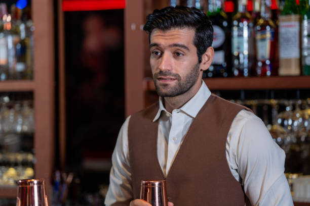 istock Man bartender is making a drink and dancing at bar. Dance party with group people dancing . Women and men have fun and drinking martini cocktail in night club. 2064373098