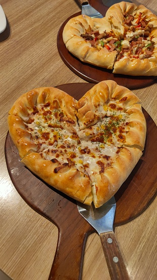 a heartful pizza serves on pan