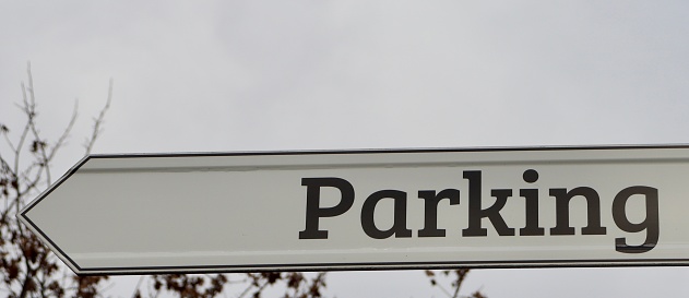 A close view of the brown and white parking sign.