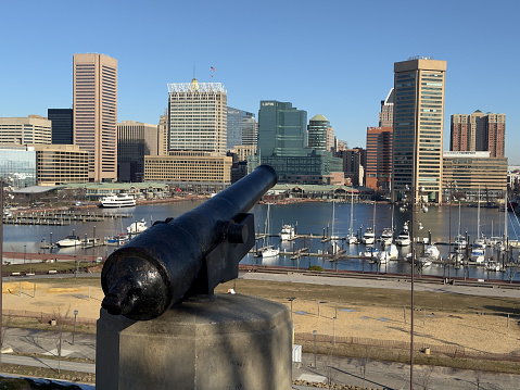 Baltimore, USA - February 18, 2024. Cannon at Federal Hill Park overlooking Inner Harbor,  Baltimore, Maryland, USA