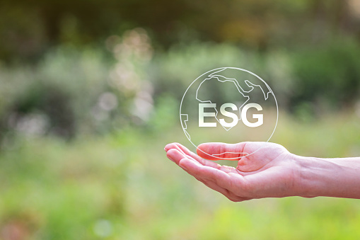 Woman Hand holding earth ESG icon for Environment Social and Governance, background with copy space. High quality photo