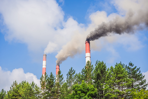 Dark black smoke from the chimney. Factory chimney smoking, heavy black smoke on the sky. ecology problems