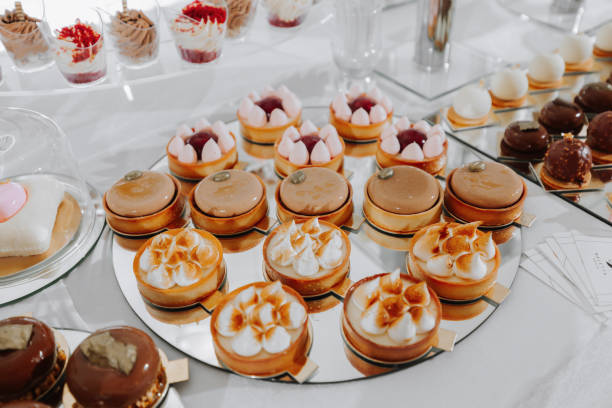 istock Festive dessert table with sweets. Wedding candy bar, various cakes, chocolates on stands. 2064419269