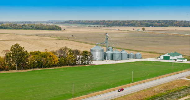 istock Car Passing Grain Silos on Country Road - Aerial 2064449246