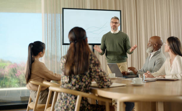 istock Businessman, mentor teaching or charts for presentation and data analysis screen in meeting. Graphs infographics, financial statistics or speaker talking on budget on monitor in workshop for speech 2064470622