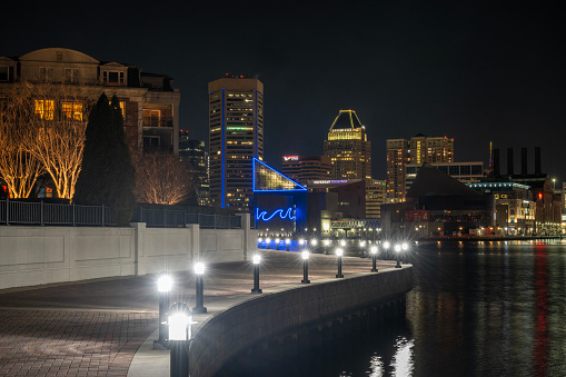 Baltimore, USA - February 17, 2024. Promenade with view of Inner Harbor at night, Baltimore, Maryland, USA
