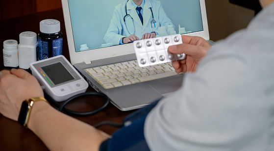 Male patient receiving telemedicine using laptop