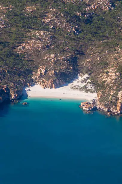 A small cove secluded by mountains and accessible only by sea in the Buccaneer Islands.