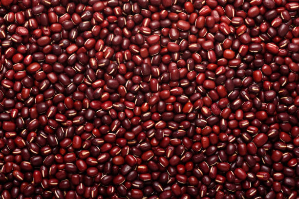 Red azuki bean seeds, an ingredient for making vegetarian and healthy food. Close-up image of food background texture stock photo