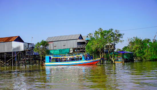 Siem Reap, Cambodia -December 11, 2023 : boat trip on the  River in Cambodia. Fishing villages and houses on the water