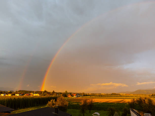 A rainbow in the cloudy sky over the fields, Nowiny, eastern Poland