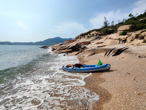 Kayak on a desert beach at Cape D'Aguilar, a cape on Hong Kong Island, Hong Kong. The cape is on the southeastern end of D'Aguilar Peninsula.