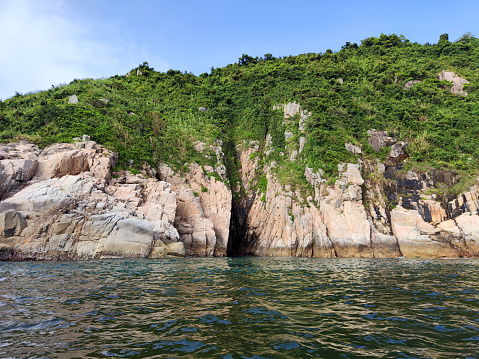 Rocky cliffs at Cape D'Aguilar, a cape on Hong Kong Island, Hong Kong. The cape is on the southeastern end of D'Aguilar Peninsula.