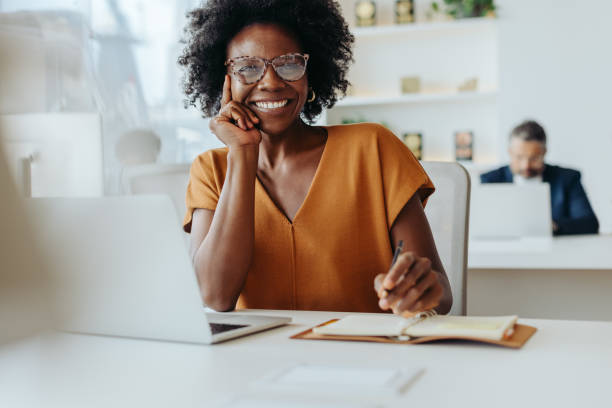istock Happy businesswoman using smartphone at modern office 2064928540