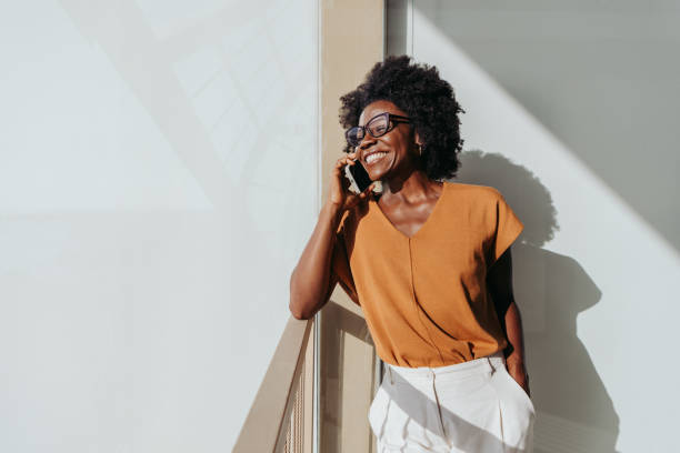 istock Professional woman talking on the phone on an office balcony 2064929055