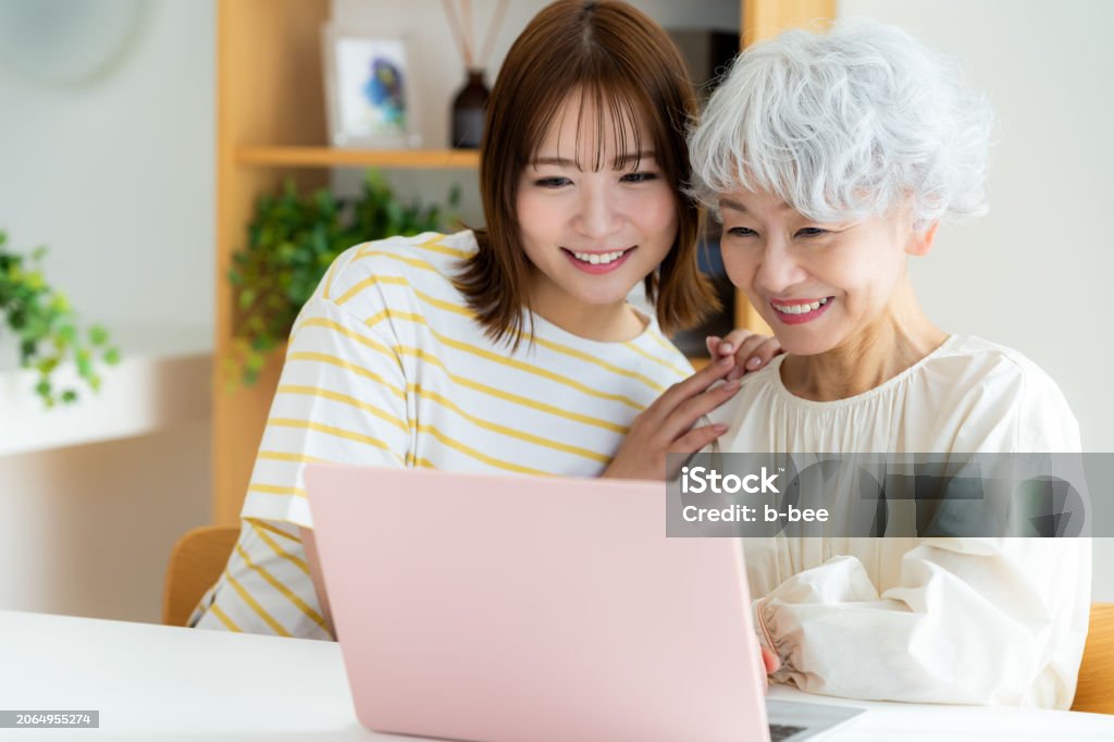 Senior woman learning how to use a computer in the living room 60-69 Years Stock Photo Senior woman learning how to use a computer in the living room 60-69 Years Stock Photo