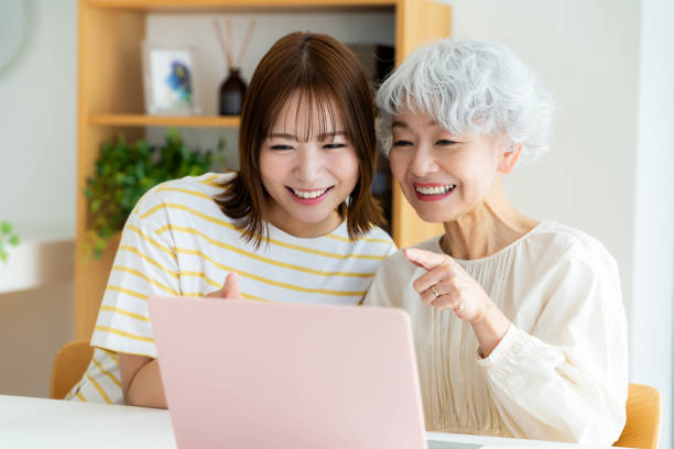 istock Senior woman learning how to use a computer in the living room 2064955278
