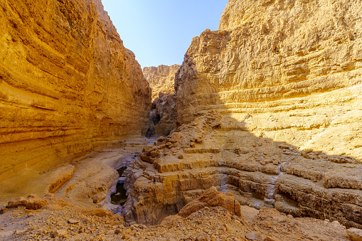 View of the landscape and cliffs of the desert Rahaf valley, with winter puddles. Dead Sea coast, Judaean Desert, southern Israel