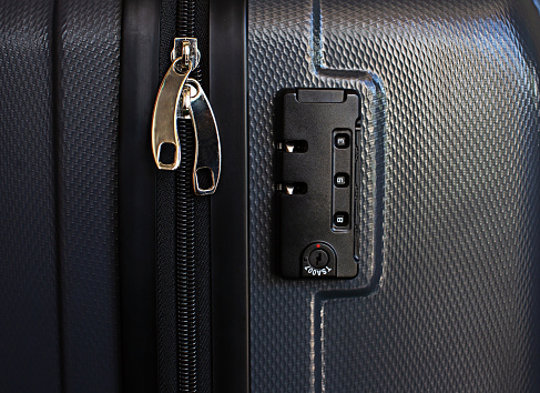 Gray luggage zip and code lock close-up photo space copy space