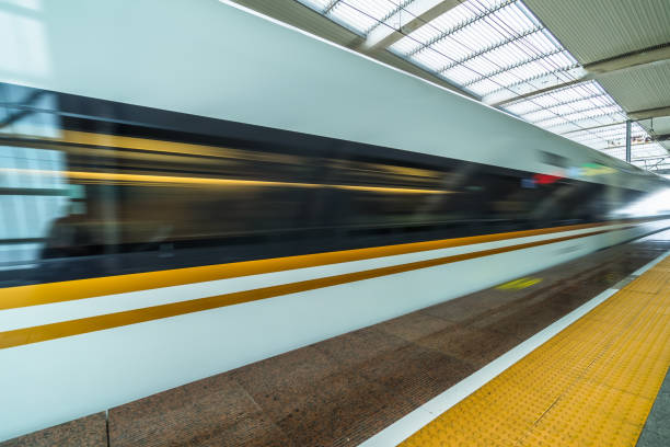 istock speeding train away from railway station 2065048000