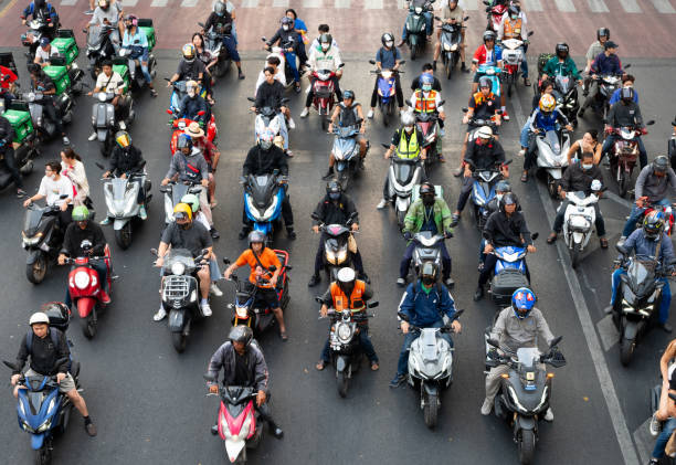istock Motorcyclists Wait at Stoplight During Rush Hour, Bangkok, Thailand 2065051146