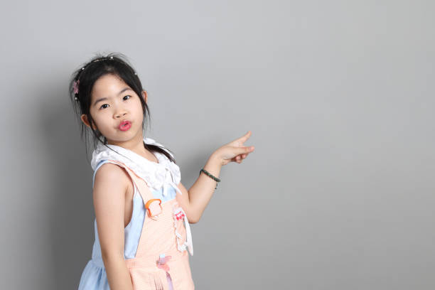 Portrait Of Girl Wearing Flowers Against White Background
