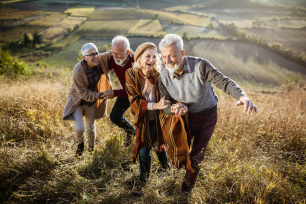 istock Happy senior couples having fun while moving up the hill in autumn day. 2065087572