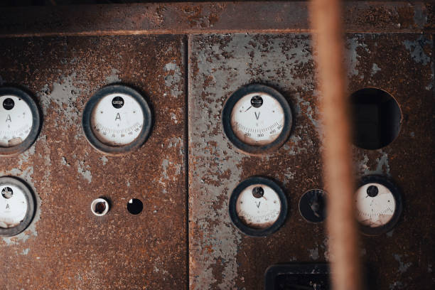 Meters of an old abandoned power plant on a rusty wall