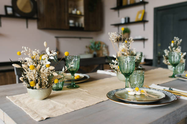istock A beautiful festive dining table in the rustic style. Dried flowers in a ceramic vase on the table 2065112824