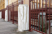 Old white wooden bollards on a pier