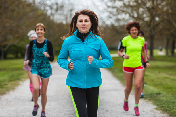 istock group of women running together through a tree-lined park 2065123451
