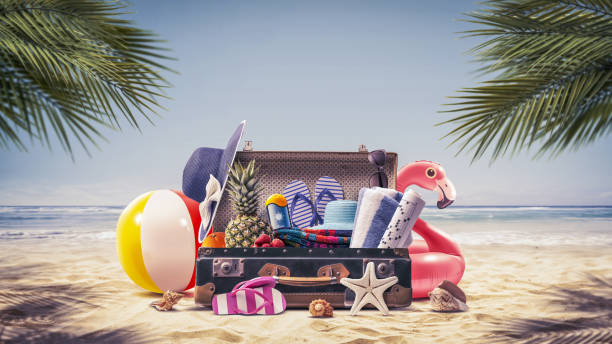 istock Suitcase with summer accessories at the beach 2065137802