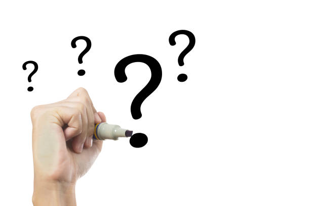 A hand holding a marker and writing question marks on a white background. The question marks are large, continuous motion. Question concept.