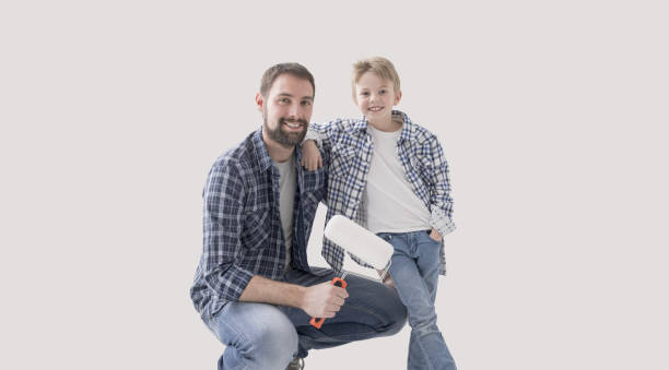 istock Father and young boy painting their home together 2065146199