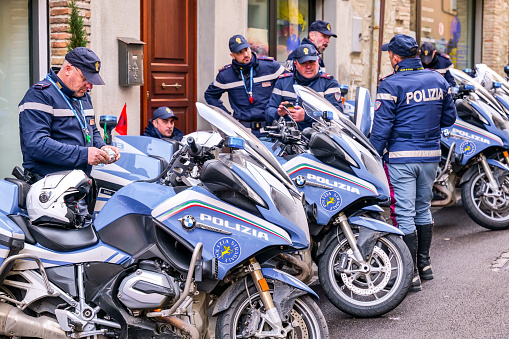 Italy, March 6 -- A team of the Highway Patrol of the Italian State Police next to their motorcycles along a street in Italy. Image in high definition quality.